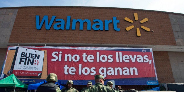 Soldiers drive past a Wal-Mart de Mexico SAB de CV store in Mexico City, Mexico on Saturday, Nov. 17, 2012. El Buen Fin, Mexico's equivalent of Black Friday, when the year's biggest discounts are offered by participating stores, is held on the third weekend of November and will run through Nov. 19. Photographer: Susana Gonzalez/Bloomberg via Getty Images