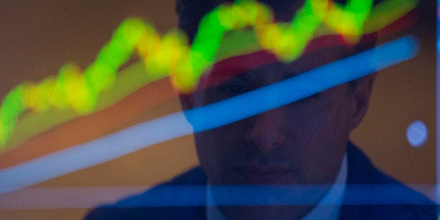 The reflection of a trader working is seen on a monitor on the floor of the New York Stock Exchange (NYSE) in New York, U.S.,