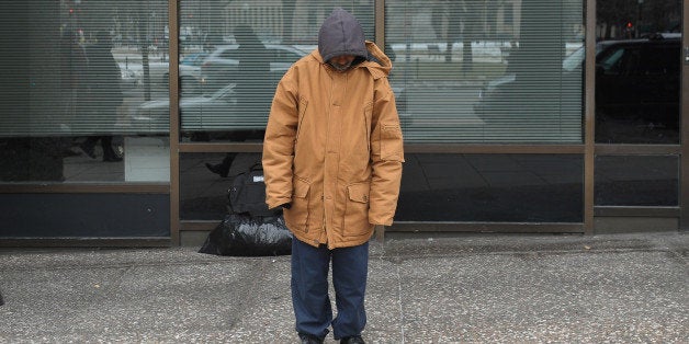 TO GO WITH AFP STORY by Joseph Krauss, US-poverty-homelessA homeless man stands in front of his belongings January 31, 2011 on a street in Washington, DC. Volunteers will begin a head count on January 26 of the homeless in downtown Washington, DC. AFP PHOTO/Mandel NGAN (Photo credit should read MANDEL NGAN/AFP/Getty Images)