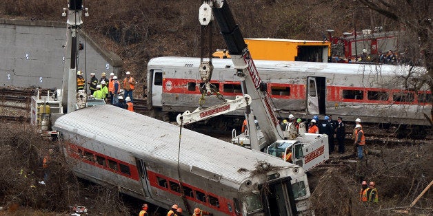 NEW YORK, NY - DECEMBER 2 : Cranes lift the derailed train wagons near the Spuyteh Duyvil station on December 2, 2013 in New York City . The Metro-North passenger train derailed en route to New York City near the Spuyten Duyvil station, killing four people and wounding 63 others on December 1, 2013 in the Bronx borough of New York City. (Photo by Cem Ozdel/Anadolu Agency/Getty Images)