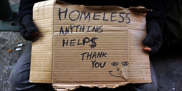 NEW YORK, NY - DECEMBER 04: A person in economic difficulty holds a homemade sign asking for money along a Manhattan street on December 4, 2013 in New York City. According to a recent study by the by the United States Department of Housing and Urban Development, New York City's homeless population increased by 13 percent at the beginning of this year. Despite an improving local economy, as of last January an estimated 64,060 homeless people were in shelters and on the street in New York. Only Los Angeles had a larger percentage increase than New York for large cities. (Photo by Spencer Platt/Getty Images)