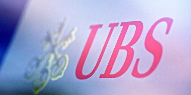 A logo sits on a sign outside a UBS AG bank branch in Lausanne, Switzerland, on Monday, Oct. 21, 2013. UBS AG, Switzerland's