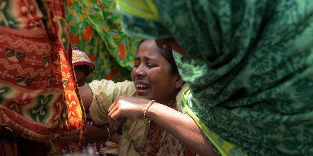 Survivors and relatives of Bangladeshi garment workers killed in the Tazreen Fashions fire accident and Rana Plaza garment factory building collapse react during a demonstration in Savar, on the outskirts of Dhaka on November 24, 2013. A fire swept through Tazreen Fashions factory, killing at least 112 workers and around 1,135 people lost their lives when the Rana Plaza complex collapsed on April 24. The protesters staged demonstrations demanding compensation for accident survivors and a full account of the missing labourers and the punishment for the garments factory owners. AFP Photo/Munir uz ZAMAN (Photo credit should read MUNIR UZ ZAMAN/AFP/Getty Images)