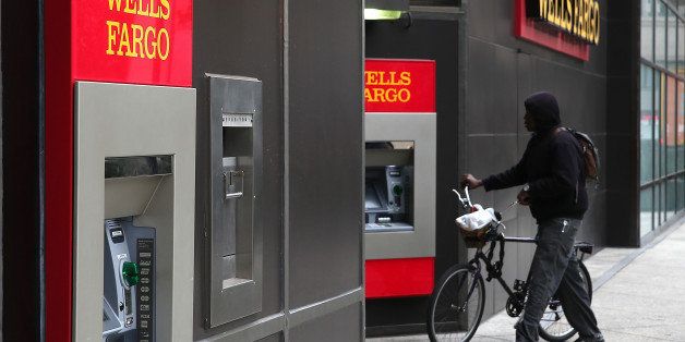 OAKLAND, CA - OCTOBER 11: A bicyclist walks by a Wells Fargo bank on October 11, 2013 in Oakland, California. Wells Fargo reported a 13 percent increase in third-quarter profits with a net income of $5.6 billion, or 99 cents a share compared to $4.9 billion, or 88 cents a share one year ago. (Photo by Justin Sullivan/Getty Images)