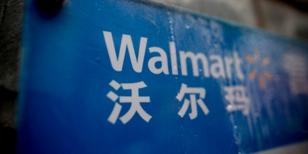 Signage for Wal-Mart Stores Inc. is displayed at one of the company's stores in the Luohu district of Shenzhen, China, on Tuesday, Dec. 17, 2013. Foreign direct investment climbed 2.4 percent last month from a year earlier, the Ministry of Commerce said. Photographer: Brent Lewin/Bloomberg via Getty Images