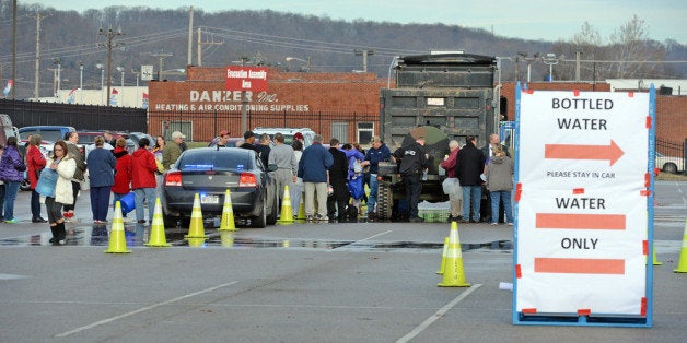 SOUTH CHARLESTON, WV - JANUARY 10: West Virginia American Water customers line up for water at the Gestamp Plant after waiting hours for a water truck, only to have it empited in about 20 minutes on January 10, 2014 in South Charleston, West Virginia. West Virginia American Water determined Thursday MCHM chemical had 'overwhelmed' the plant's capacity to keep it out of the water from a spill at Freedom Industries in Charleston. An unknown amount of the hazardous chemical contaminated the public water system for potentially 300,000 people in West Virginia. (Photo by Tom Hindman/Getty Images)