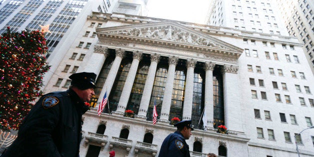 New York City police officers walk past the New York Stock Exchange (NYSE) in New York, U.S., on Friday, Dec. 27, 2013. U.S. stocks rose, sending the Standard & Poors 500 Index to a fifth day of gains, amid optimism over the economic recovery. Photographer: Jin Lee/Bloomberg via Getty Images