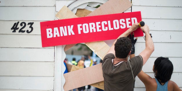 Protesters work on a prop in Freedom Plaza as they prepare for a rally against big banks and home foreclosures in Washington,