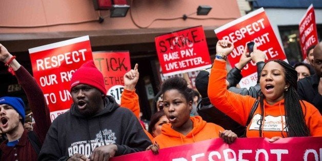 NEW YORK, NY - DECEMBER 05: Protesters rally outside of a Wendy's in support of raising fast food wages from $7.25 per hour to $15.00 per hour on December 5, 2013 in the Brooklyn borough of New York City. A growing number of fast food workers in the United States have been staging protests outside restaurants, calling for a raise in wages, claiming it is impossible to live resonably while earning minimum wage. (Photo by Andrew Burton/Getty Images)