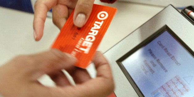 UNITED STATES - FEBRUARY 19: A customer uses her Target credit card at a Target store in El Cerrito, California on Thursday, February 19, 2004. Target Corp. and Wal-Mart Stores Inc., the two largest U.S. discount retailers, said fourth-quarter profit rose as customers bought more winter clothing and holiday gifts. (Photo by Noah Berger/Bloomberg via Getty Images)