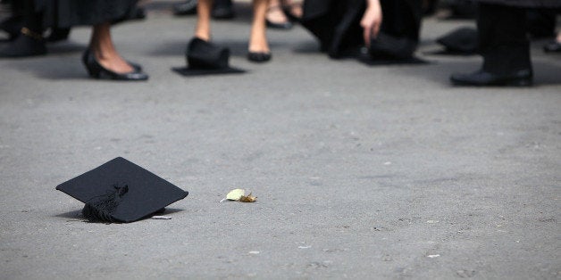 BIRMINGHAM, ENGLAND - JULY 14: Students pick up their mortarboards after the offical hat throwing photograph at the University of Birmingham on July 14, 2009 in Birmingham, England. Over 5000 graduates will be donning their robes this week to collect their degrees from The University of Birmingham. A recent survey suggested that there are 48 graduates competing for every job. (Photo by Christopher Furlong/Getty Images)