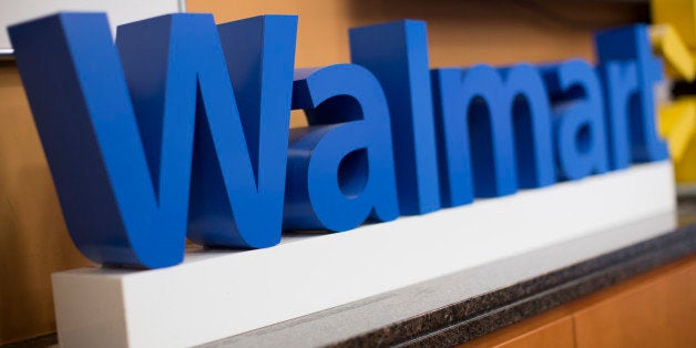 The Wal-Mart Stores Inc. logo is displayed during a media briefing with Scott Price, chief executive officer for Asia at Wal-Mart, in Hong Kong, China, on Wednesday, Dec. 18, 2013. Indias antitrust body approved Wal-Marts purchase of a stake in its former partner Bharti Enterprises Pvt., Price said in Hong Kong today. Photographer: Jerome Favre/Bloomberg via Getty Images