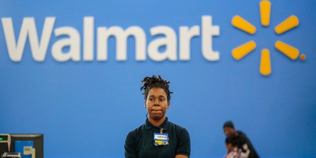 WASHINGTON, DC - DECEMBER, 21: Christina Ford, stands by to help customers at the self checkout registers at a new Wal-Mart in Washington, DC, Saturday December 21, 2013. Ford, who was laid off from her job working at a group home for the elderly and was out of work for more than a year and living in a homeless shelter with her children, was hired by Wal-Mart in October. (Photo by Dayna Smith/For The Washington Post via Getty Images)