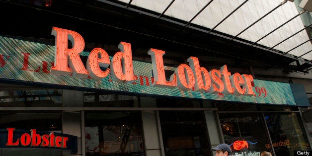 Pedestrians pass a Red Lobster restaurant in Times Square, New York, U.S., on Tuesday, March 23, 2010. Darden Restaurants Inc., the owner of casual dining chains including Red Lobster and the Olive Garden, is scheduled to announce quarterly earnings tomorrow after the U.S. market close. Photographer: Jonathan Fickies/Bloomberg via Getty Images