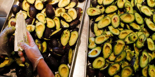 An employee slices avocados to be made into fresh guacamole at a Chipotle Mexican Grill Inc. restaurant in Hollywood, California, U.S., on Tuesday, July 16, 2013. Chipotle Mexican Grill Inc. is scheduled to release earnings data on July 18. Photographer: Patrick T. Fallon/Bloomberg via Getty Images