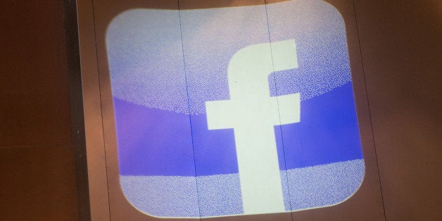 A logo from the Facebook Inc. social networking website is projected onto the wall of the Armani Hotel during a news conferen