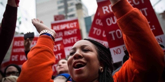 NEW YORK, NY - DECEMBER 05: Protesters rally outside of a Wendy's in support of raising fast food wages from $7.25 per hour to $15.00 per hour on December 5, 2013 in the Brooklyn borough of New York City. A growing number of fast food workers in the United States have been staging protests outside restaurants, calling for a raise in wages, claiming it is impossible to live resonably while earning minimum wage. (Photo by Andrew Burton/Getty Images)