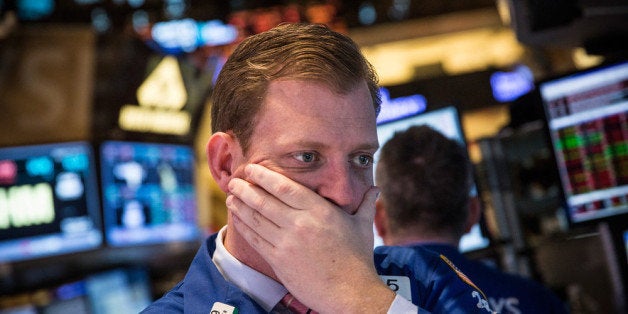 NEW YORK, NY - MARCH 19: A trader on the floor of the New York Stock Exchange reacts to an announcement from the Federal Res