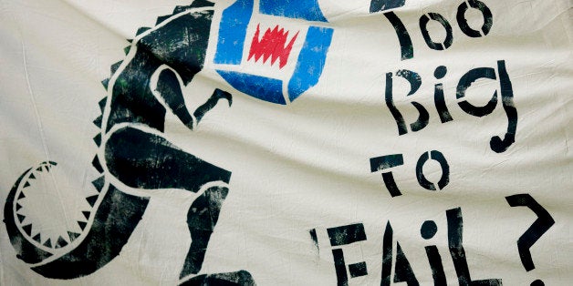 A 'Too big to fail' sign is held up by Occupy Wall Street movement demonstrators at Union Square in New York, U.S., on Tuesday, May 1, 2012. Occupy Wall Street demonstrators took to the streets in May Day protests from New York to California, picketing banks in Oakland with helicopters overhead and sending a singing 'Guitarmy' to Manhattan's Union Square. Photographer: Victor J. Blue/Bloomberg via Getty Images