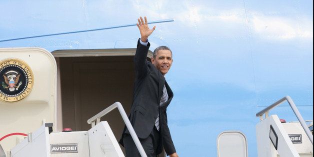 ROME, ITALY - MARCH 28: US President Barack Obama waves as he walks down the stairs from Air Force One upon leaves at Fiumicino Airport on March 28, 2014 in Rome, Italy. Obama is on a week-long trip during which he will visit the Italy and Saudi Arabia. (Photo by Ernesto Ruscio/Getty Images)