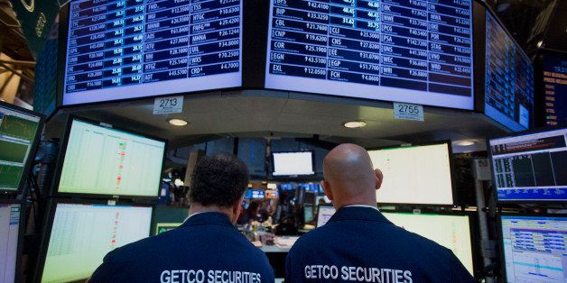 Traders view monitors while working in the Getco LLC booth on the floor of the New York Stock Exchange (NYSE) in New York, U.S., on Wednesday, Nov. 28, 2012. Getco LLC, the Chicago-based high-frequency trader, offered to buy Knight Capital Group Inc. (KCG) for about $1 billion in a move to expand its market-making business. Photographer: Scott Eells/Bloomberg via Getty Images