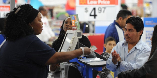 An employee rings up sales at a cash register at a Walmart in the Crenshaw district of Los Angeles on Black Friday, November 29, 2013. US stocks Friday moved higher in a holiday-shortened session following better eurozone economic data and positive early assessments of 'Black Friday' shopping traffic by some leading retailers. AFP PHOTO / Robyn Beck (Photo credit should read ROBYN BECK/AFP/Getty Images)