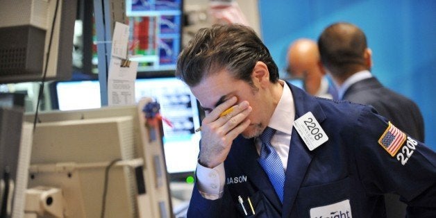 Jason Blatt of Knight Capital Americas, LP reacts to down market on the floor of the New York Stock Exchange August 8, 2011.