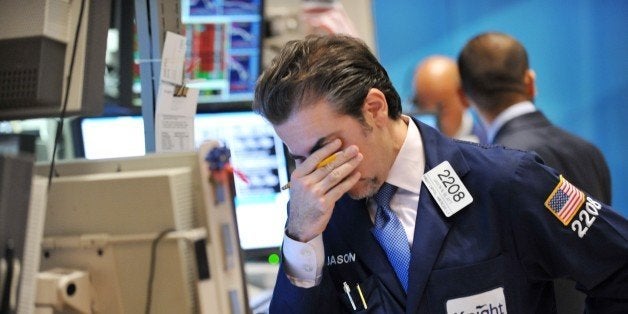 Jason Blatt of Knight Capital Americas, LP reacts to down market on the floor of the New York Stock Exchange August 8, 2011. US stocks plummeted more than five percent on Monday, with the Dow Jones Industrial Average losing 625 points in the wake of Standard & Poor's unprecedented downgrade of the United States. The Dow was down 5.5 percent to 10,813.26 in closing trade, its lowest close since last October, while the broader S&P 500 fell 6.6 percent and the tech-heavy Nasdaq dropped 6.9 percent. AFP PHOTO / Stan HONDA (Photo credit should read STAN HONDA/AFP/Getty Images)