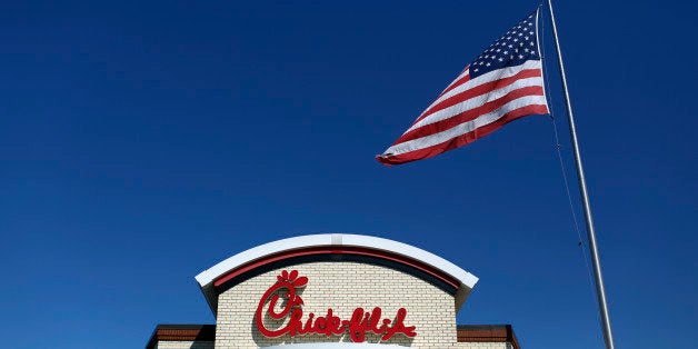 A U.S. flag flies outside a Chick-fil-A Inc. restaurant in Bowling Green, Kentucky, U.S., on Tuesday, Mar. 25, 2014. The U.S. economy grew more rapidly in the fourth quarter than previously estimated as consumer spending climbed by the most in three years, showing the expansion had momentum heading into this years harsh winter. Photographer: Luke Sharrett/Bloomberg via Getty Images