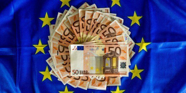 A picture taken on April 25, 2014, in Lille, shows 50-euro notes displayed on an European Union flag. European Central Bank chief Mario Draghi said recently that the bank may need to take action to stem the rising euro. AFP PHOTO PHILIPPE HUGUEN (Photo credit should read PHILIPPE HUGUEN/AFP/Getty Images)