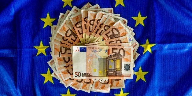 A picture taken on April 25, 2014, in Lille, shows 50-euro notes displayed on an European Union flag. European Central Bank c