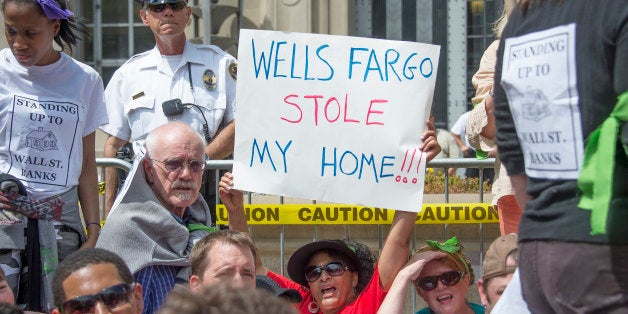 Protester sit down in front of a police barricade in front of the US Department of Justice during a rally against big banks and home foreclosures in Washington, DC, May 20, 2013. AFP PHOTO/JIM WATSON (Photo credit should read JIM WATSON/AFP/Getty Images)