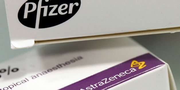 A box of Arthrotec 50 tablets, produced by Pfizer Inc., top, and a box of EMLA cream, produced by AstraZeneca Plc, are seen in this arranged photograph taken in London, U.K., on Monday, April 28, 2014. U.S. drugmaker Pfizer proposed buying AstraZeneca for about 58.8 billion pounds ($98.7 billion) in what would rank as the industry's biggest-ever takeover, surpassing Pfizer's $64 billion purchase of Wyeth in 2009. Photographer: Simon Dawson/Bloomberg via Getty Images
