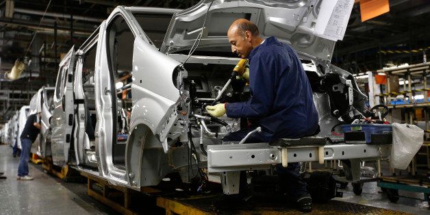 An employee works under the hood of a Vauxhall Vivaro truck on the production line at the Vauxhall plant, operated by General Motors Co., in Luton, U.K., on Friday, Oct. 25, 2013. General Motors is working to turn around its European operations, which have accumulated more than $18 billion in losses since 1999, and has a target for the business to break even by 2015. Photographer: Simon Dawson/Bloomberg via Getty Images