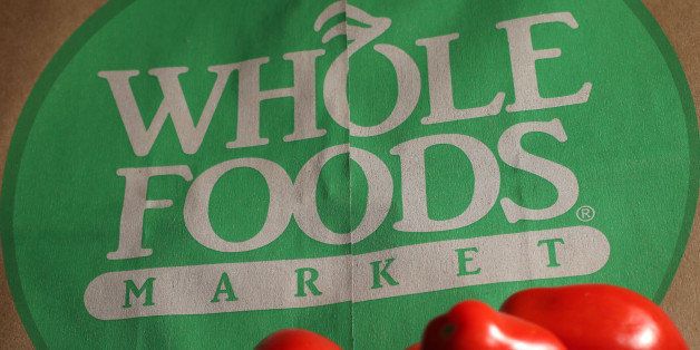 In this Monday, July 29, 2013, photo, produce is places on Whole Foods paper bag in Andover, Mass. Whole Foods Market Inc. reports quarterly financial results after the market closes on Wednesday, July 31, 2013. (AP Photo/Elise Amendola)