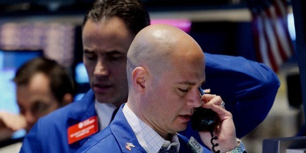Stock specialists at the Barclays post work on the floor of the New York Stock Exchange just before the opening bell May 13,