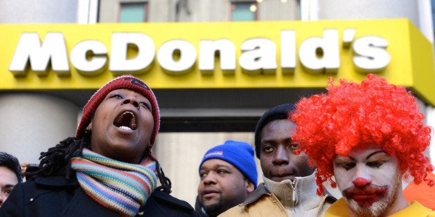 NEW YORK, UNITED STATES - MARCH 19: Fast-food workers calling for better wages demonstrate outside a McDonald's restaurant on New York's Fifth Avenue, in New York, United States on March 18, 2014. Fast-food workers are demanding $15 an hour, up from $7.25, the current minimum wage. (Photo by Cem Ozdel/Anadolu Agency/Getty Images)