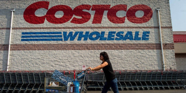 A customer pushes a cart of purchased items outside a Costco Wholesale Corp. store in Hackensack, New Jersey, U.S., on Wednesday, Sept. 11, 2013. The U.S. Census Bureau is scheduled to release business inventories data on Sept. 13. Photographer: Ron Antonelli/Bloomberg via Getty Images