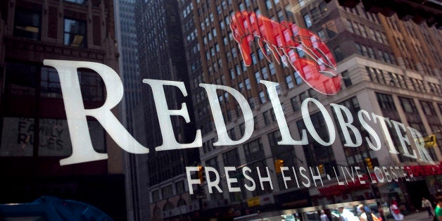 Red Lobster signage is displayed in the window of a restaurant in New York, U.S., on Thursday, June 9, 2011. Red Lobster, a chain owned by Darden Restaurants Inc., is trying to create the ambiance of a small, seaside town in Maine as it rolls out a three-year remodeling plan for its 700 U.S. and Canadian restaurants. Photographer: Robert Caplin/Bloomberg via Getty Images