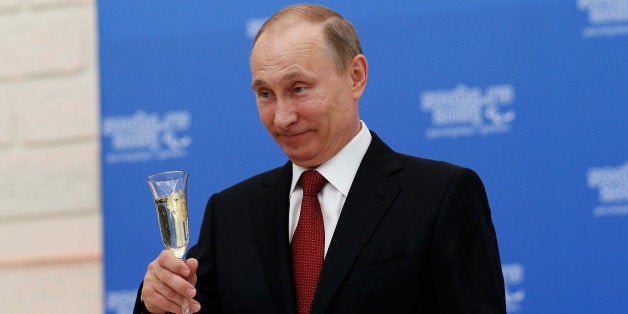 SOCHI, RUSSIA - MARCH 13: Russian President Vladimir Putin holds a glass of champagne during a lunch hosted by the office of