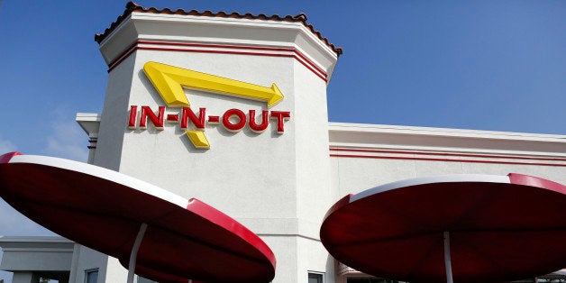 Customers enter an In-N-Out Burger restaurant in Costa Mesa, California, U.S., on Wednesday, Feb. 6, 2013. In-N-Out, with almost 280 units in five states, is valued at about $1.1 billion based on the average price-to-earnings, according to the Bloomberg Billionaires Index. Photographer: Patrick T. Fallon/Bloomberg via Getty Images