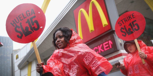 CHICAGO, IL - MAY 15: Fast food workers and activists demonstrate outside McDonald's downtown flagship restaurant on May 15, 2014 in Chicago, Illinois. The demonstration was one of several nationwide calling for wages of $15 per hour and better working conditions for fast food workers. (Photo by Scott Olson/Getty Images)