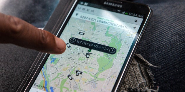 WASHINGTON, DC - APR 4: UberX driver, Michael Belet, checks the Uber customer app to see where other Uber drivers are working so he can determine where the best place for him to get fares might be, April 7, 2014, in Washington, DC. Thousands of local car owners have signed up in recent months to drive with one of the 'ride-share' operators that use smartphone apps to link people needing rides with car owners willing to give them, for a price. (Photo by Evelyn Hockstein/For The Washington Post via Getty Images)