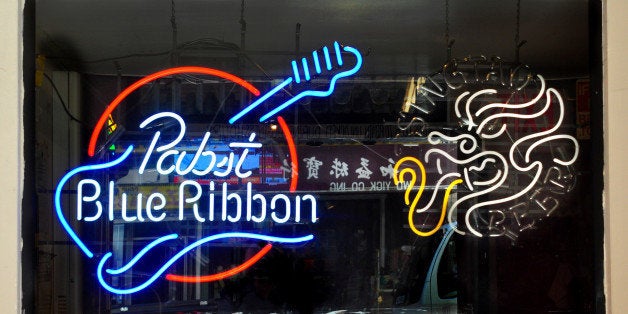 SAN FRANCISCO, CA - MAY 13, 2013: A Pabst Blue Ribbon neon sign hangs in the window of the Li Po Lounge in the Chinatown section of San Francisco. A sign taped in the window declares that Anthony Bourdain filmed a segment of his Travel Channel TV show at the lounge in 2012. The city's Chinatown neighborhood is the oldest Chinatown in North America and the largest Chinese community outside Asia. Established in the 1840s, Chinatown is an active community that continues to retain its own customs, languages, traditions, social clubs and identity. (Photo by Robert Alexander/Getty Images)