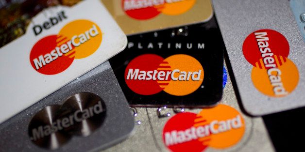 MasterCard Inc. credit and debit cards are arranged for a photograph in Washington, D.C., U.S., on Wednesday, Jan. 29, 2014. MasterCard Inc. is expected to release earnings data on Jan. 31. Photographer: Andrew Harrer/Bloomberg via Getty Images