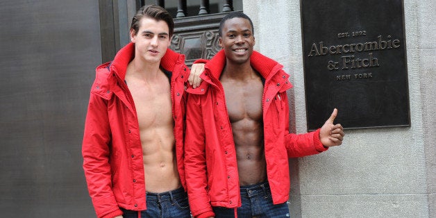 MUNICH, GERMANY - OCTOBER 25: Male models pose outside the Abercrombie & Fitch flagship clothing store before the opening of Abercrombie & Fitch Munich flagship store on October 25, 2012 in Munich, Germany. (Photo by Hannes Magerstaedt/Getty Images)