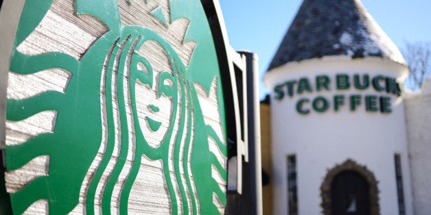 Starbucks Corp. signage is displayed outside a Starbucks location in Glen Rock, New Jersey, U.S., on Wednesday, Jan. 22, 2014. Starbucks Corp. is scheduled to release earnings figures on January 23. Photographer: Ron Antonelli/Bloomberg via Getty Images