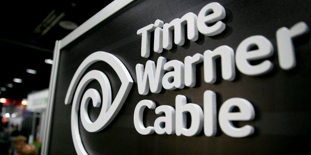 The Time Warner Cable Inc. logo is seen on the exhibit floor during the National Cable and Telecommunications Association (NCTA) Cable Show in Washington, D.C., U.S., on Tuesday, June 11, 2013. The Cable Show is expected to bring in more than 10,000 attendees with 286 companies on the exhibit floor. Photographer: Andrew Harrer/Bloomberg via Getty Images