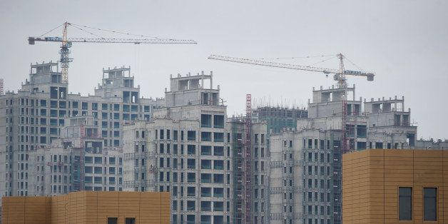 A photo taken on August 18, 2012 shows ongoing construction in the inner Mongolian city of Ordos. Miss China won the coveted title of Miss World on August 18, triumphing on home soil during a glitzy final held in a mining city on the edge of the Gobi desert. The city has grown rich over the past decade on the back of a coal mining boom that has transformed it from a sandstorm-afflicted backwater into one of the wealthiest places in China. The boom triggered a frenzy of building in the city, but the local government has struggled to fill the vast tower blocks that sprung up, earning it the title of China's biggest ghost town. AFP PHOTO / Ed Jones (Photo credit should read Ed Jones/AFP/GettyImages)