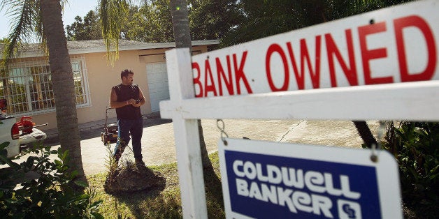 MIAMI, FL - NOVEMBER 10: Renzo Salazar maintains the yard around a foreclosed home after the bank hired him to keep the home from falling into complete dilapidation on November 10, 2011 in Miami, Florida. RealtyTrac reported that foreclosures were up 7 percent in October from the prior month as defaults in California, Florida and Michigan hit 12-month highs. (Photo by Joe Raedle/Getty Images)